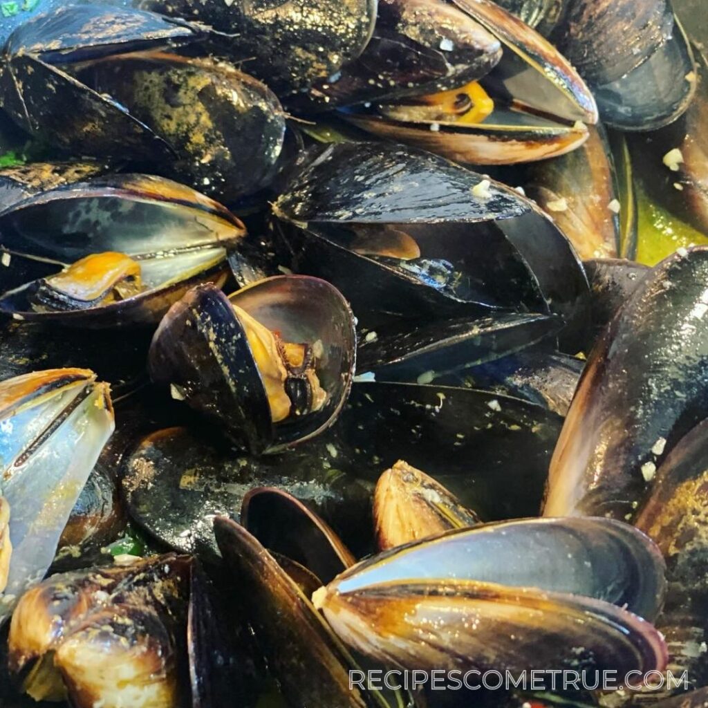 mussels pop open in a pan