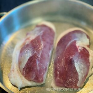 duck breasts in a frying pan